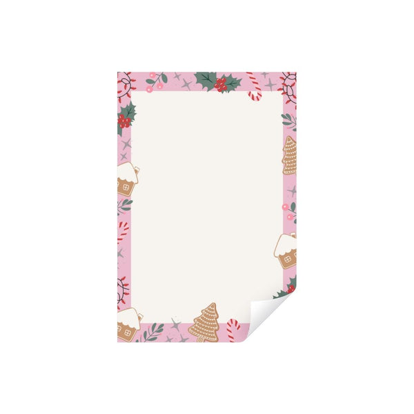 Single blank notepad sheet with a curled bottom corner, framed by a pink border of gingerbread houses, holly, and candy canes on a white background