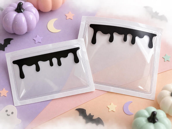 Two clear adhesive vinyl planner pockets with black drip design