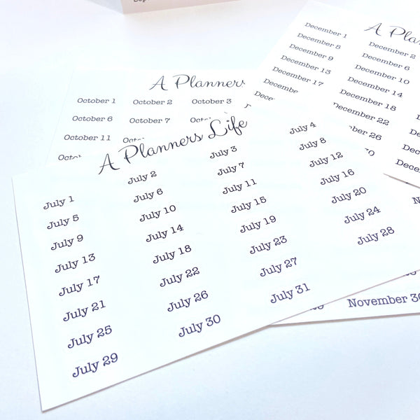 Fanned-out sheets of monthly date stickers for July, October, November, and December