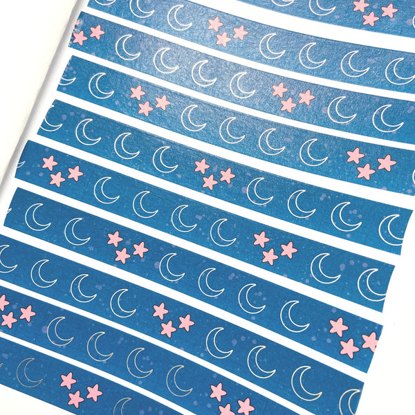 Rows of unrolled blue washi tape with moon and star pattern showing the full repeating design