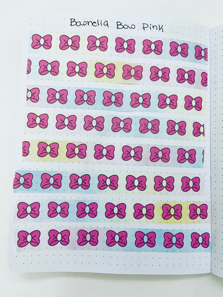 Pink bow washi tape rolled out flat showing repeating bow pattern